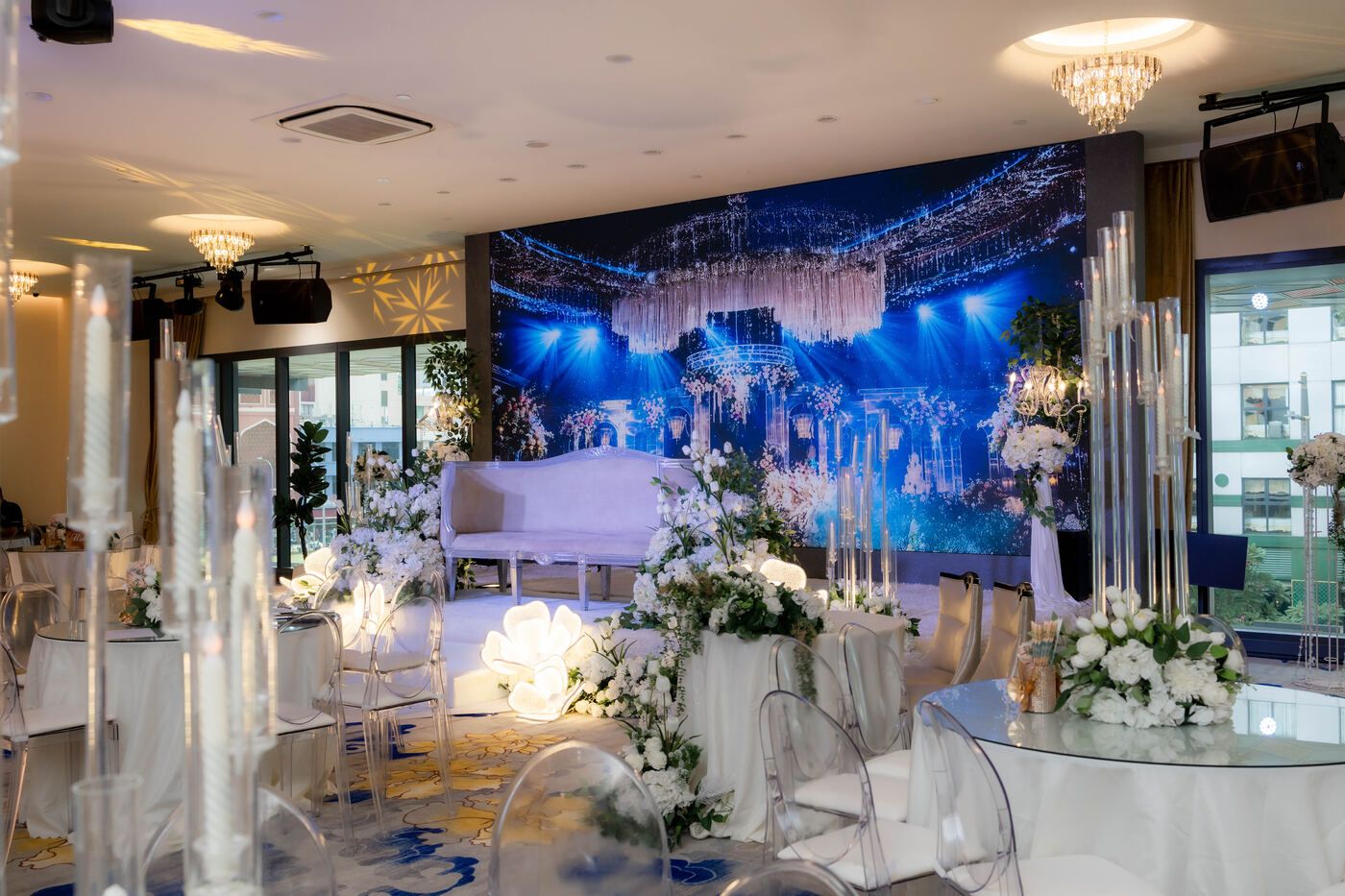 De Villa ballroom with floral wedding stage and chandelier lighting